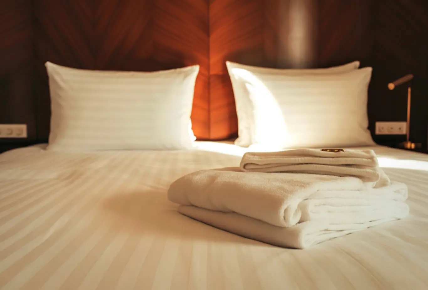 clean bed with fresh towels and linens on it